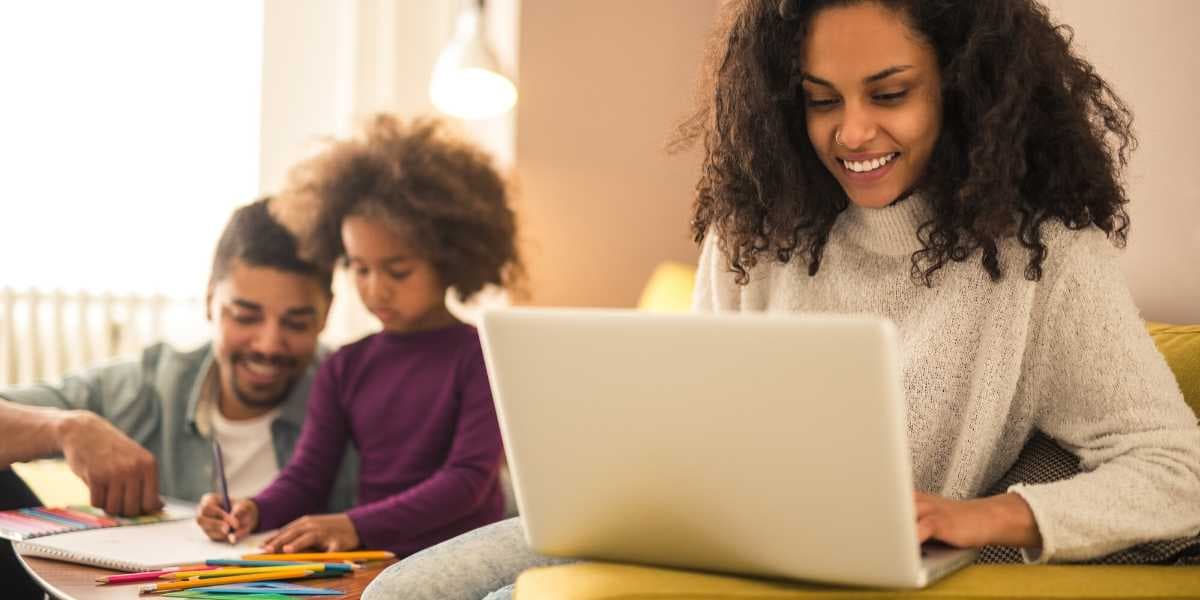 Woman working on computer with family